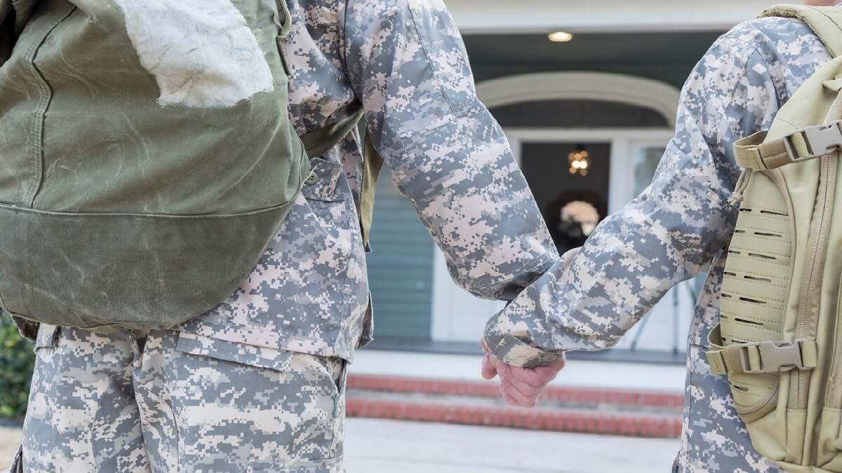 A military couple holds hands