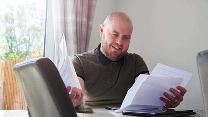 Homeowner looking through refinancing paperwork