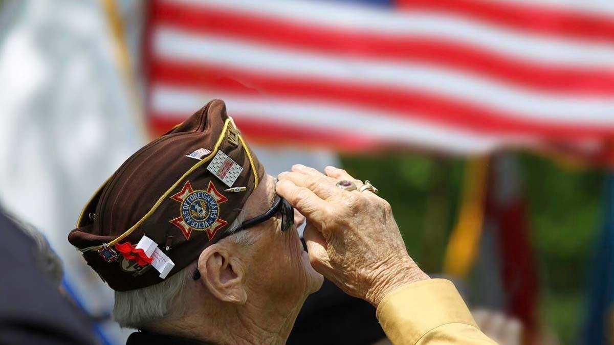 A senior veteran salutes the American Flag 